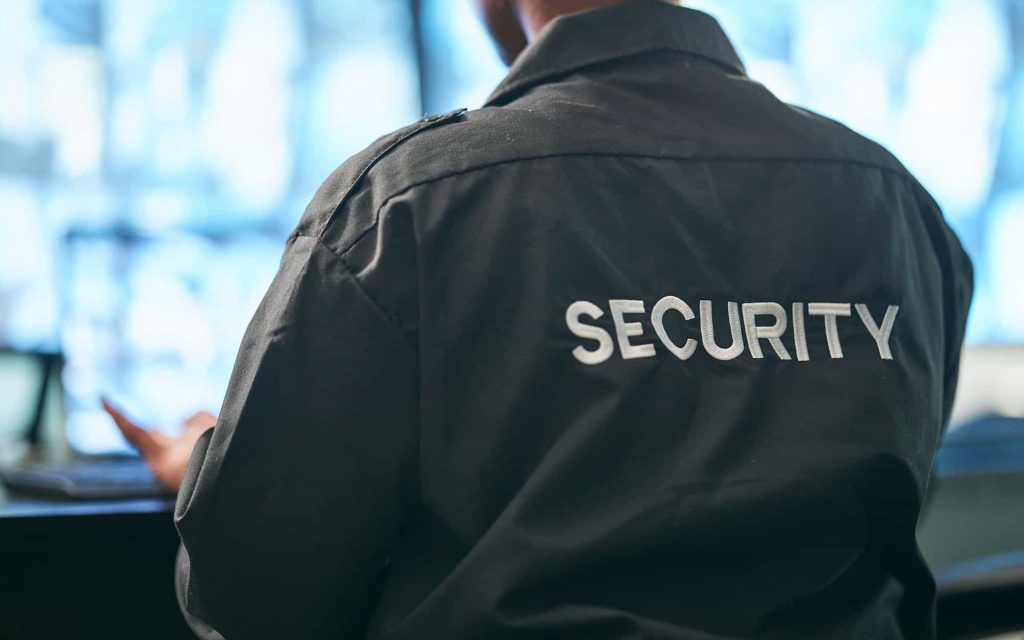 back view of a man with a security jacket on