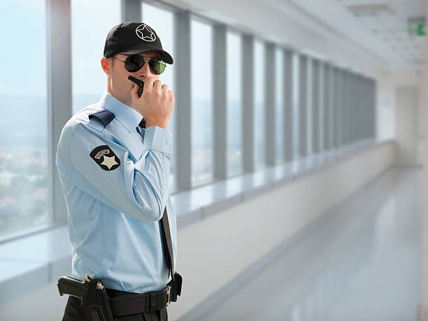security guard is talking with walkie talkie .