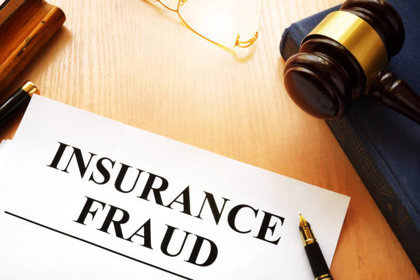 insurance fraud written on a documents and gavel.
